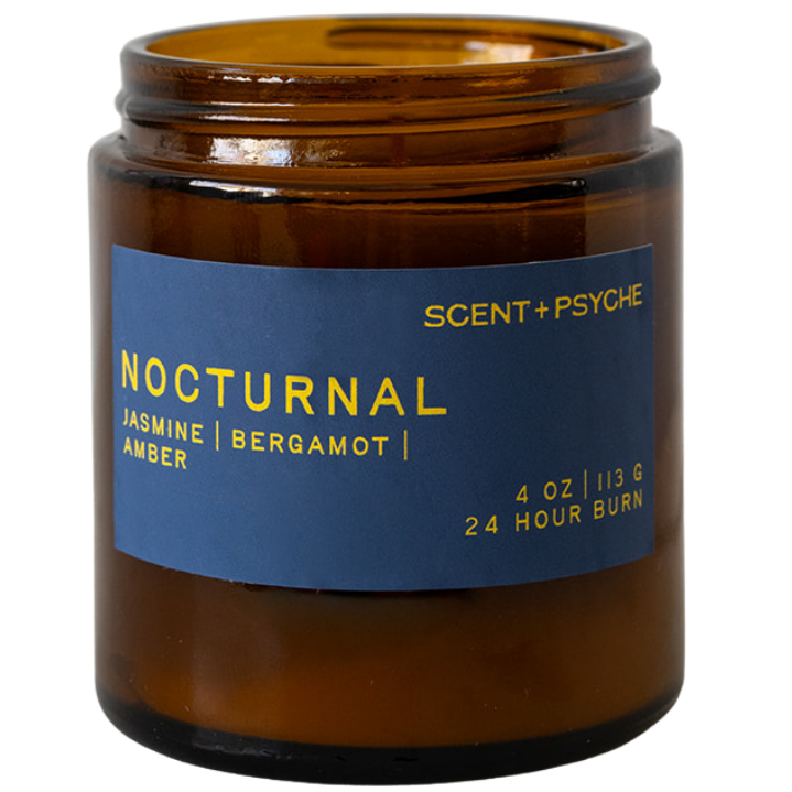 An amber glass jar candle with a blue label reading 'NOCTURNAL' and 'SCENT+PSYCHE' on a white background.