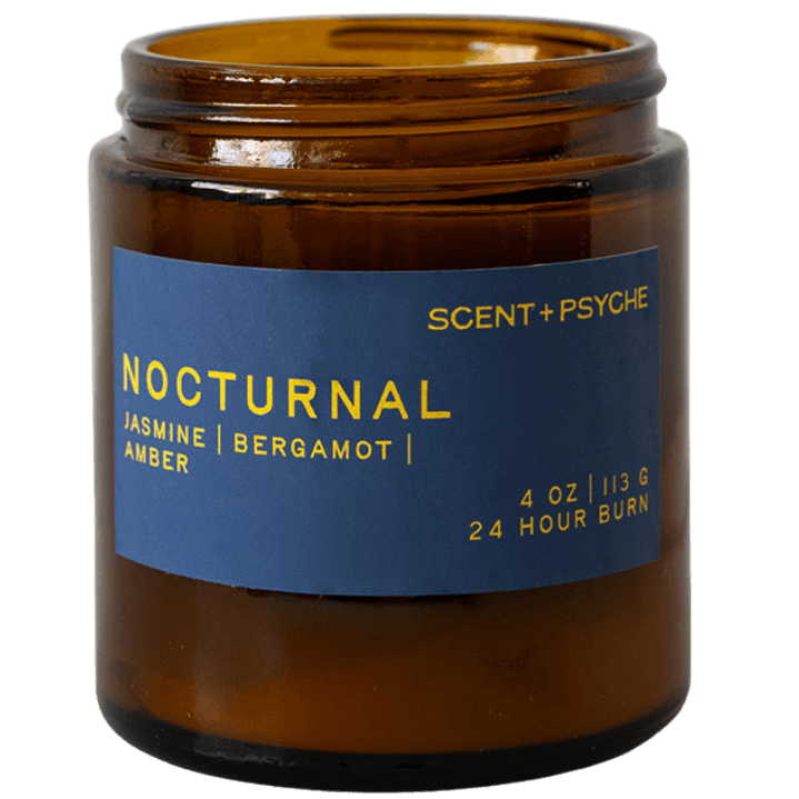 An amber glass jar candle with a blue label reading 'NOCTURNAL' and 'SCENT+PSYCHE' on a white background.