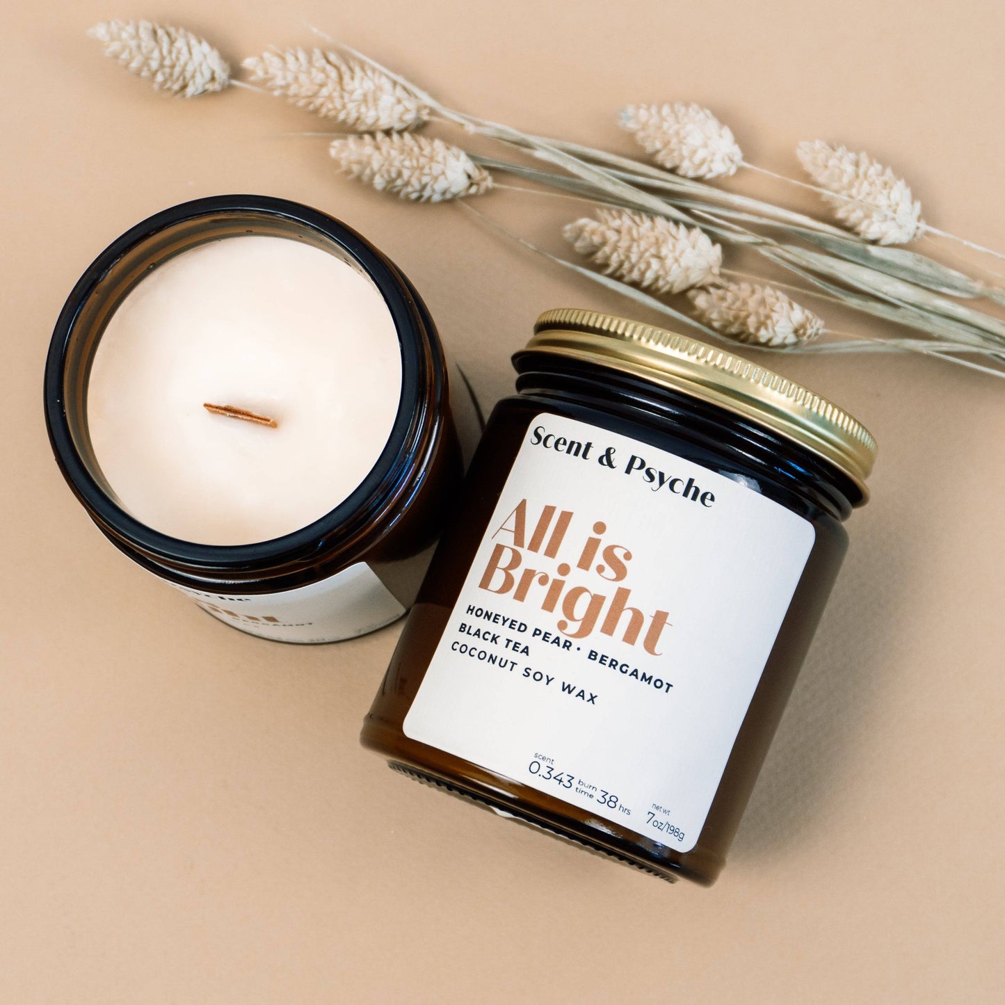 All is Bright Scented Candle in 7oz amber jar with gold lid, featuring notes of honeyed pear, black tea, and bergamot. Ideal for holiday home decor.