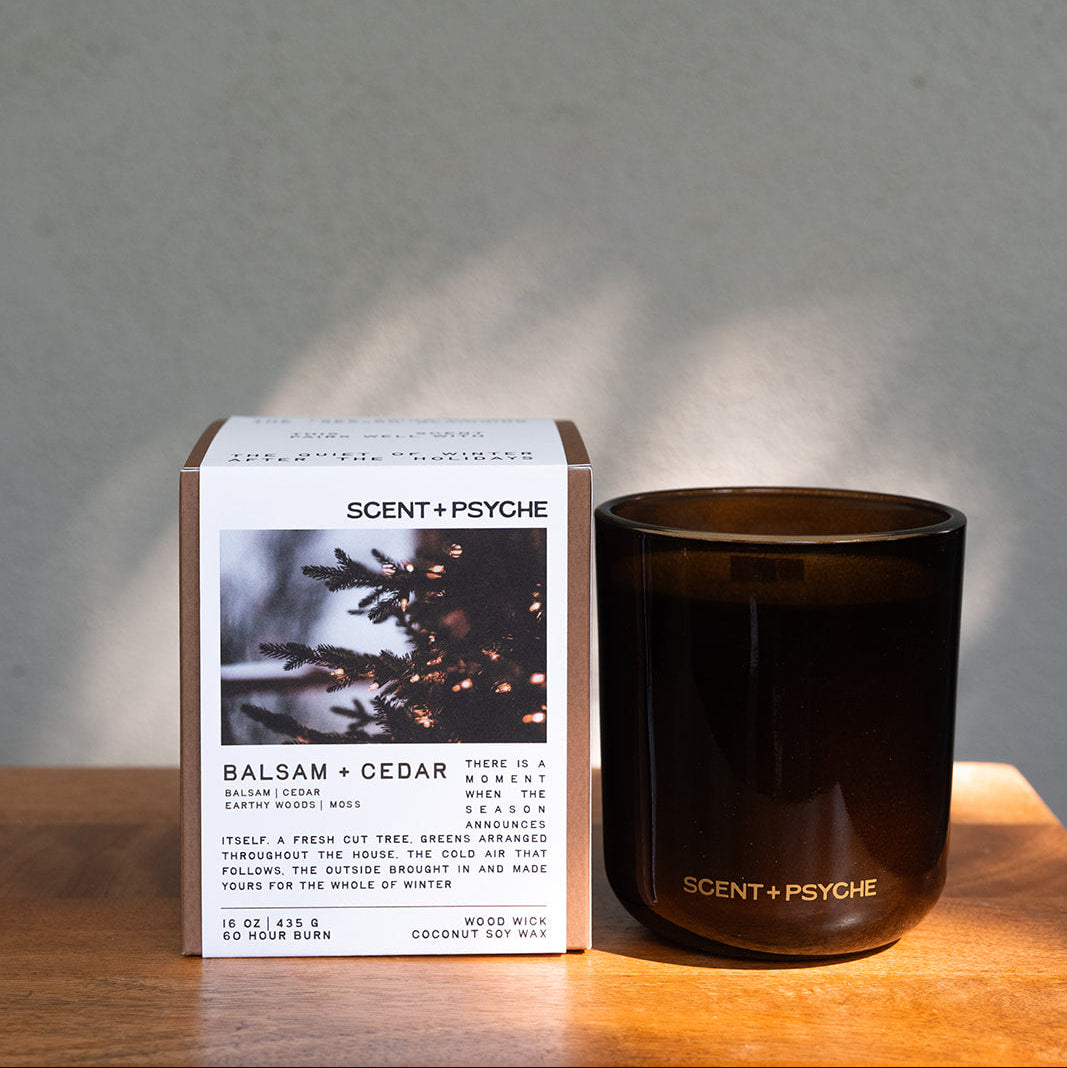 Balsam + Cedar Statement size candle next to its Scent + Psyche gift box in window light