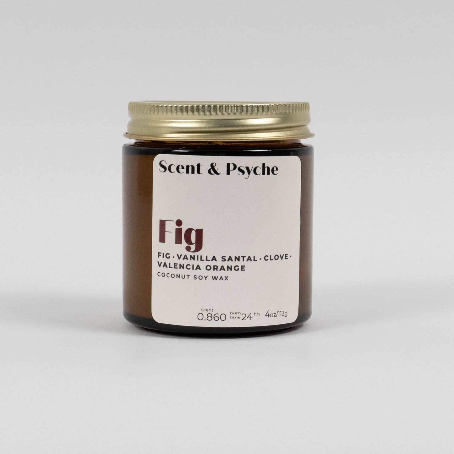 Fig scented candle in a 4oz amber jar with a gold lid. Features notes of fig, vanilla santal, clove, and Valencia orange, made from coconut soy wax.