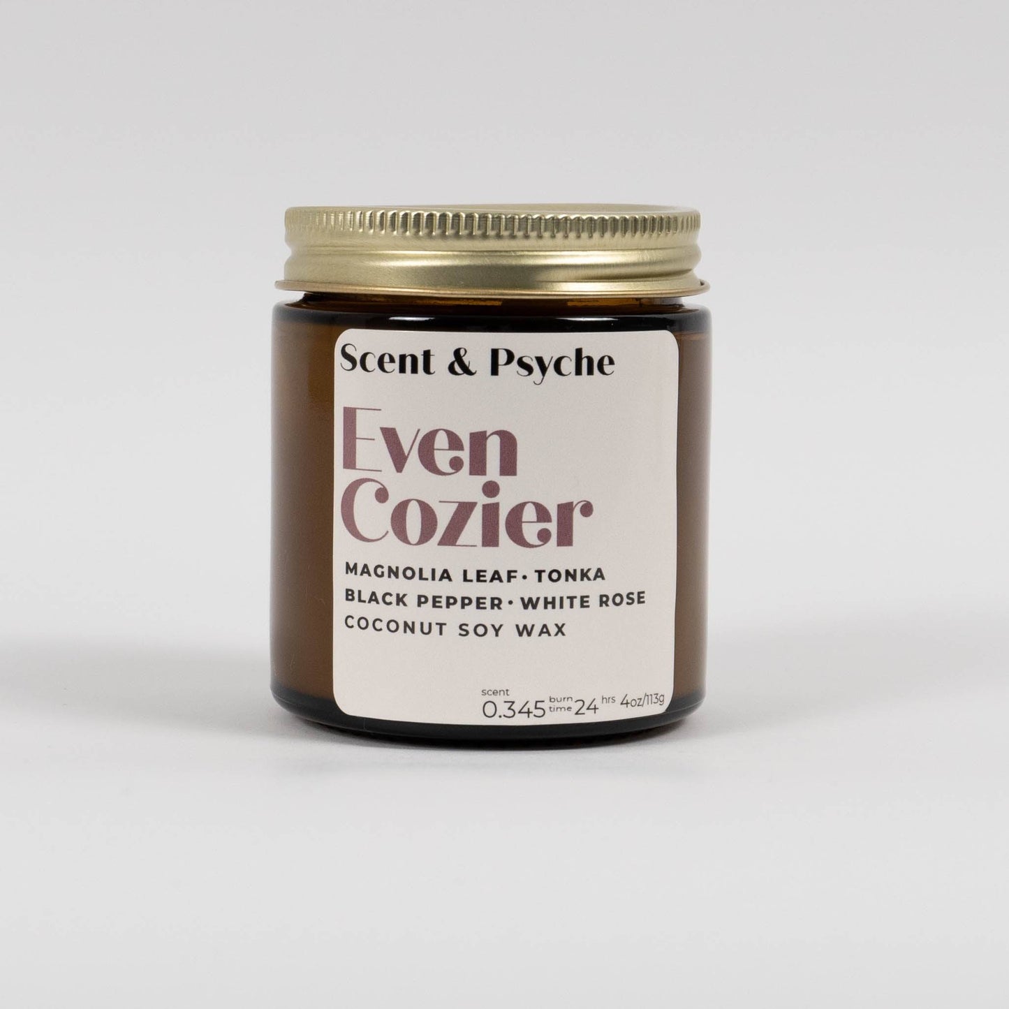 Even Cozier Scented Candle 4oz in amber jar with gold lid, featuring coconut soy wax and phthalate-free fragrance for home decor and relaxation.