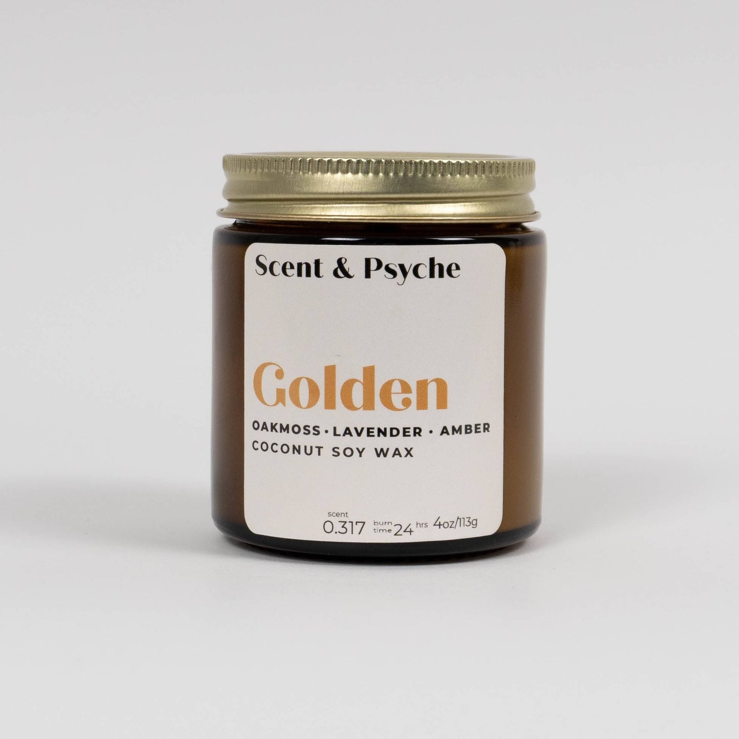 Golden Scented Candle in a 4oz amber jar with a gold lid, featuring oakmoss, lavender, and amber fragrance. Made with coconut soy wax for a clean burn.