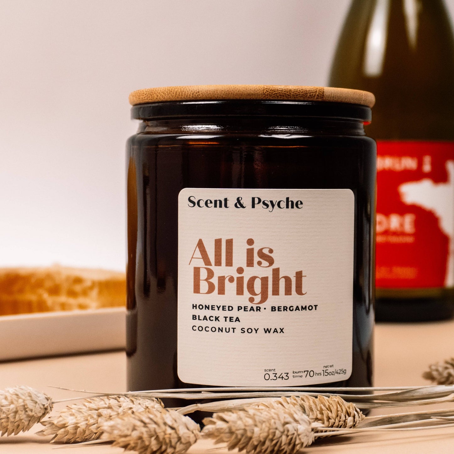 All is Bright Scented Candle - 15oz in amber jar with wooden lid, featuring notes of honeyed pear, bergamot, and black tea. Ideal for holiday home decor.