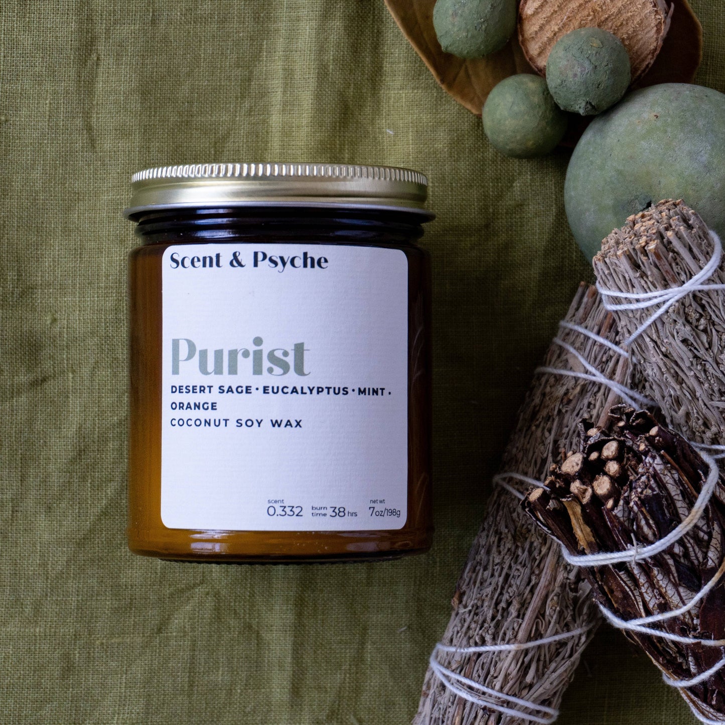 Purist Scented Candle in a 7oz amber jar with a coconut soy wax blend. Features notes of desert sage, eucalyptus, mint, and orange. Perfect for home fragrance and relaxation.