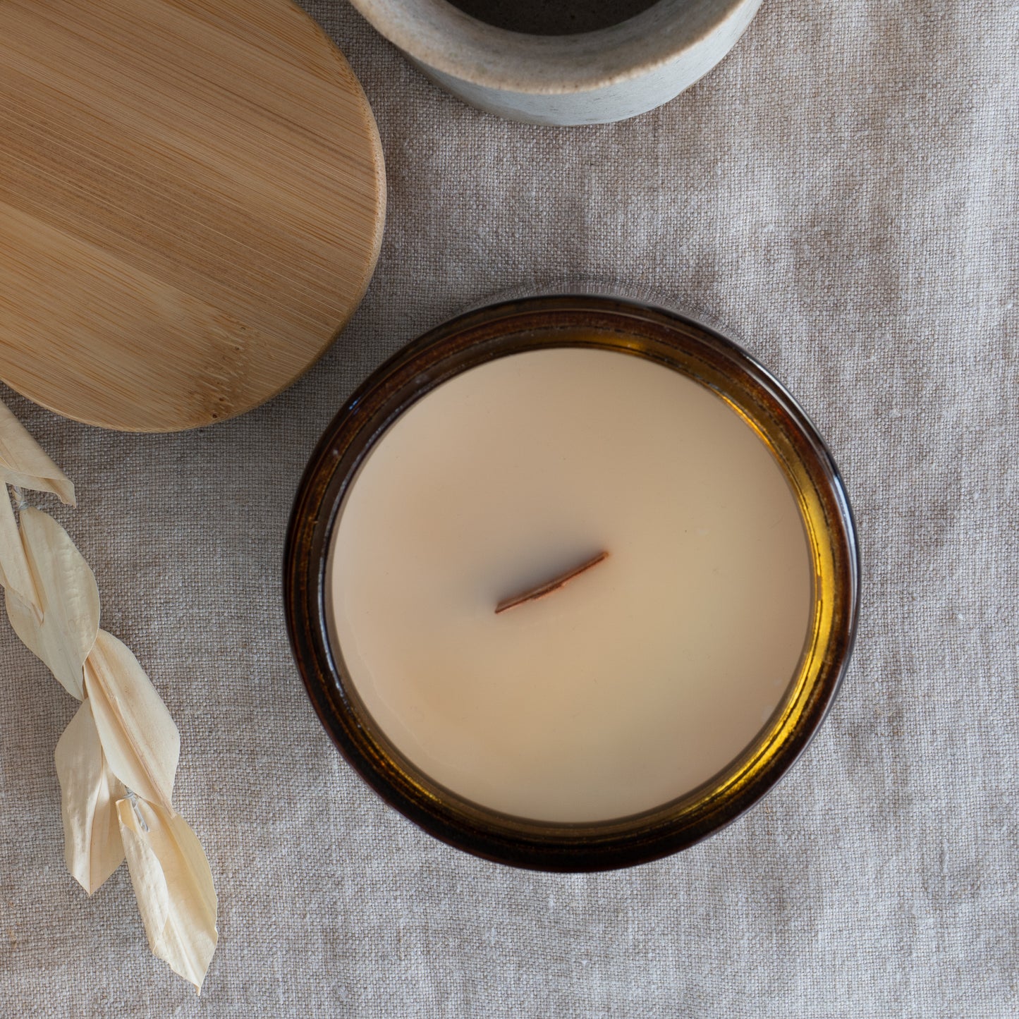 Top view of Fresh Start Wood Wick Scented Candle in a 15oz amber jar. Showcases a smooth coconut soy wax surface with a centered wooden wick.