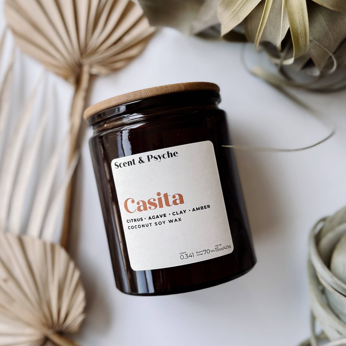 Casita Scented Candle - 15oz in an amber glass jar with a wooden lid. Features coconut soy wax with citrus, agave, clay, and amber fragrance.