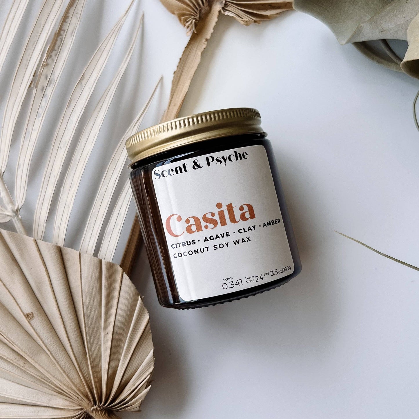 Casita Scented Candle in a 4oz amber jar with a minimalist label, featuring notes of citrus, agave, clay, and amber. Made from coconut soy wax.