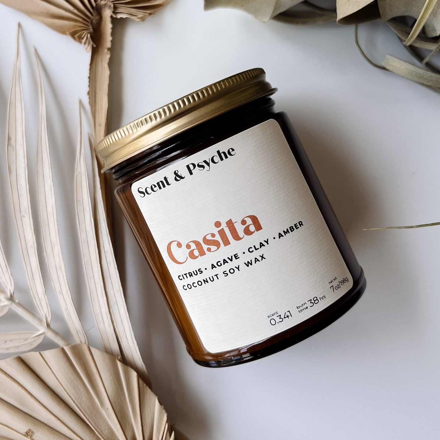 Casita Scented Candle in a 7oz amber jar with a gold lid, featuring notes of citrus, agave, clay, and amber. Made from coconut soy wax for a clean burn.