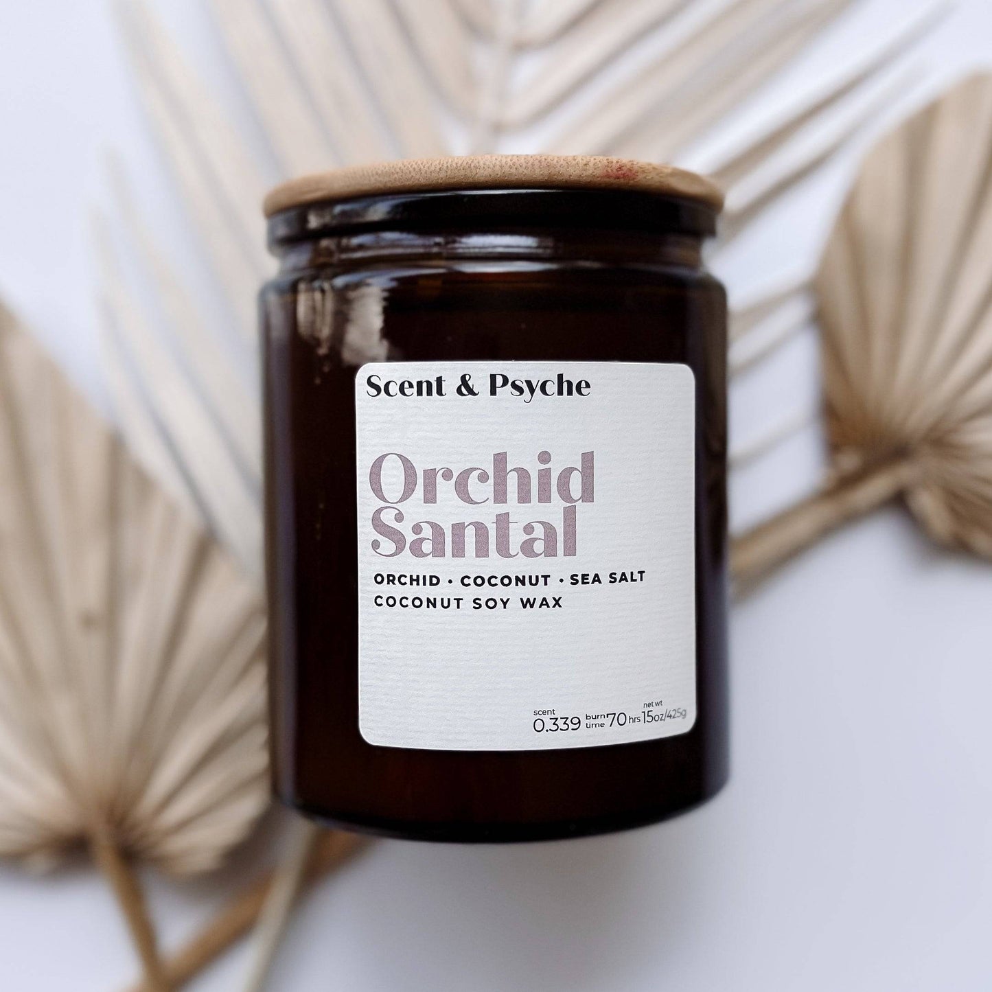 Orchid Santal Scented Candle - 15oz in an amber glass jar with a wooden lid. Features coconut soy wax with notes of orchid, coconut, and sea salt.