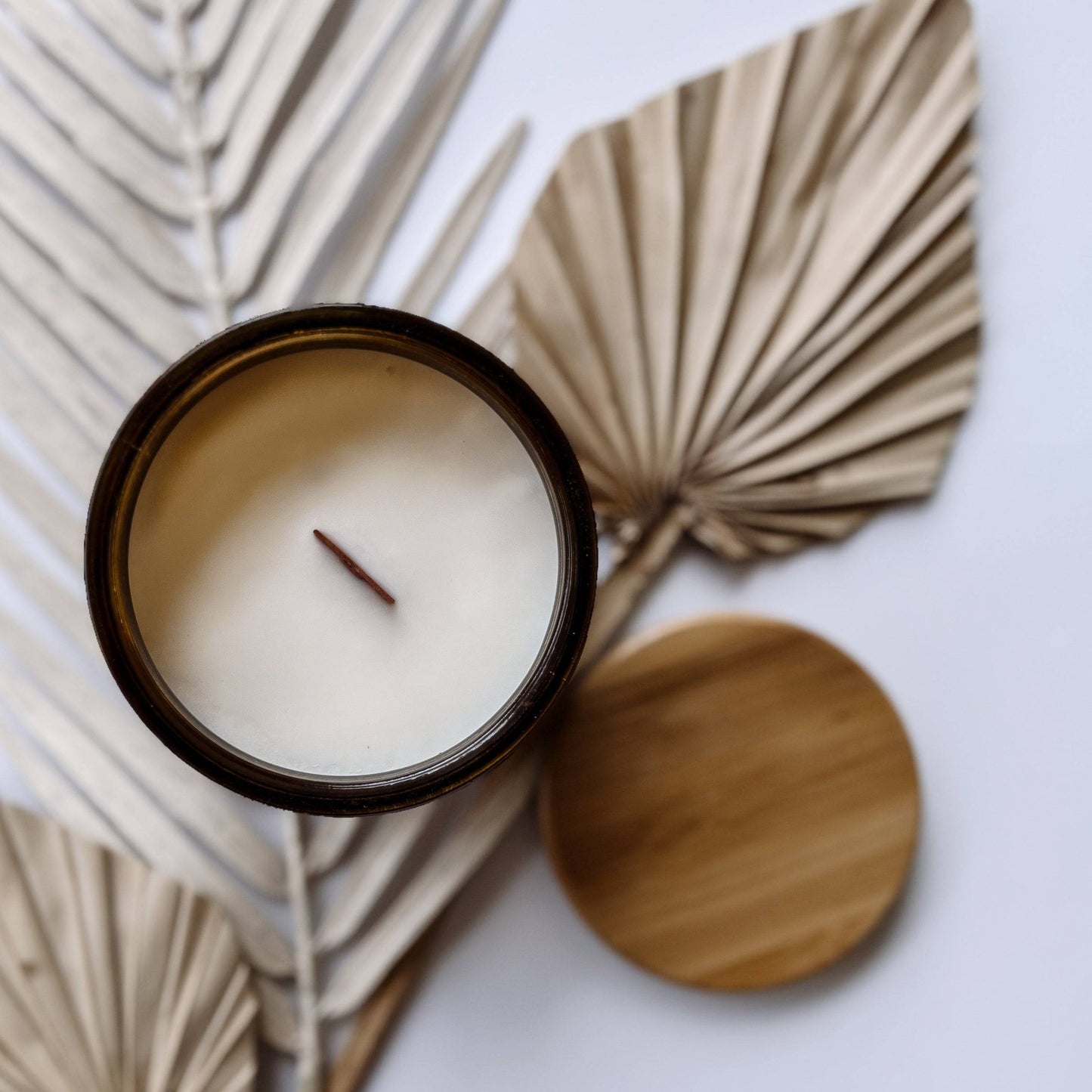 Top view of the Orchid Santal Scented Candle in a 12oz amber jar, showcasing a wooden wick and creamy soy wax. Elegant home fragrance for a cozy ambiance.