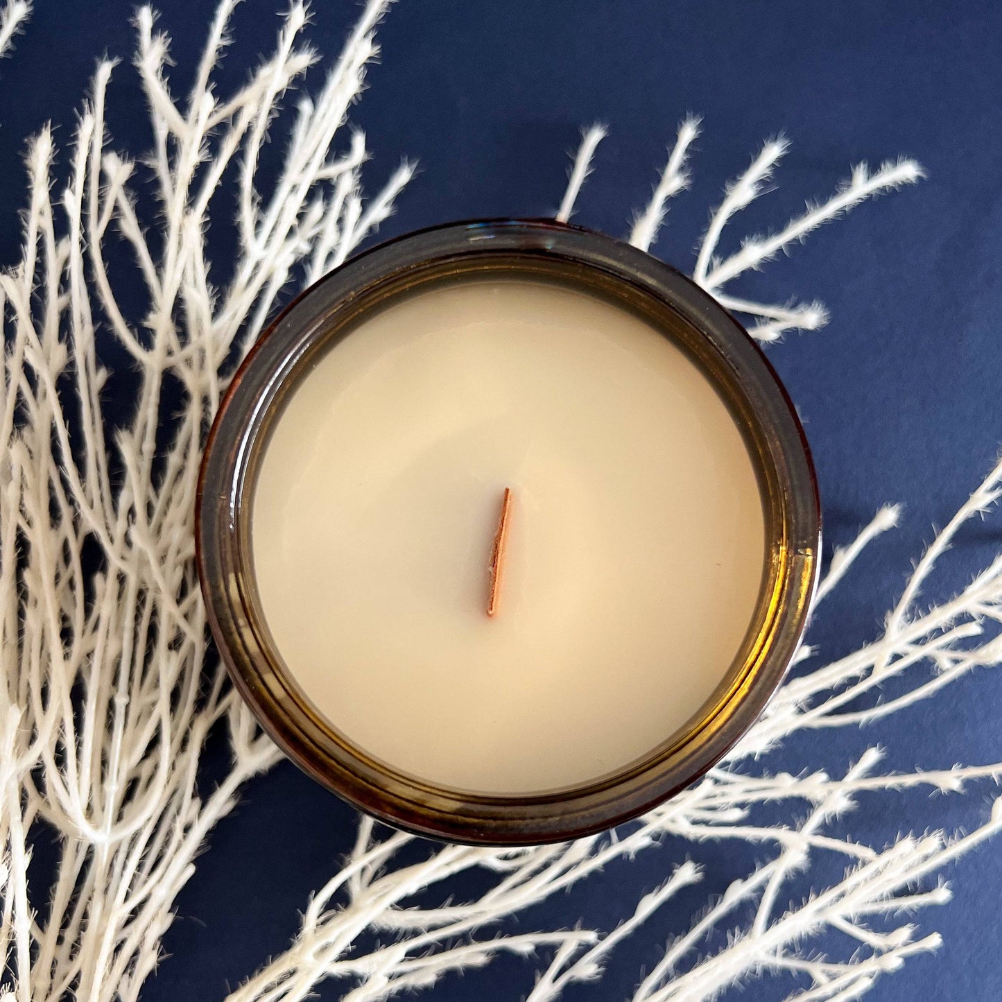 Top view of Nocturnal Scented Candle in a 12oz amber jar, showcasing smooth coconut soy wax and a centered wooden wick. Perfect for a cozy ambiance.