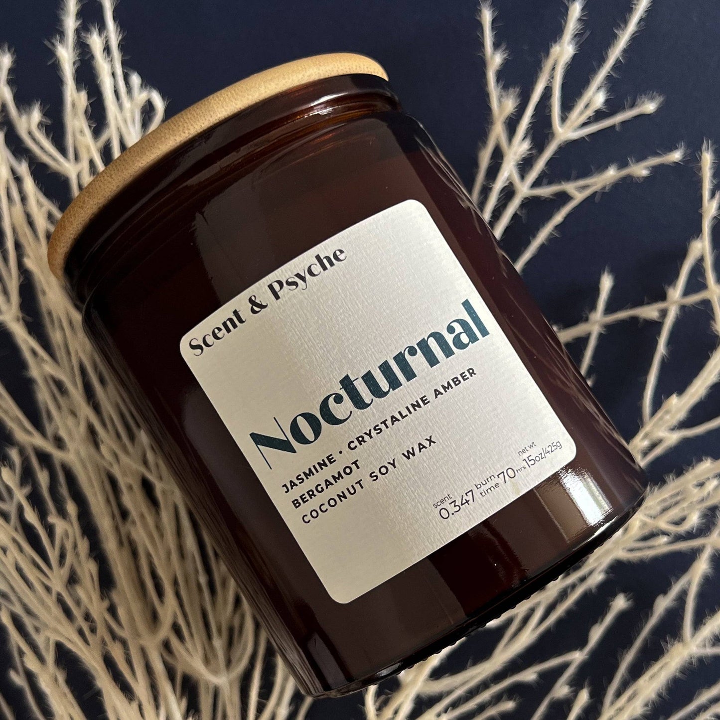 Nocturnal Scented Candle - 15oz in an amber glass jar with a minimalist label featuring jasmine, crystalline amber, and bergamot notes. Perfect for home ambiance.