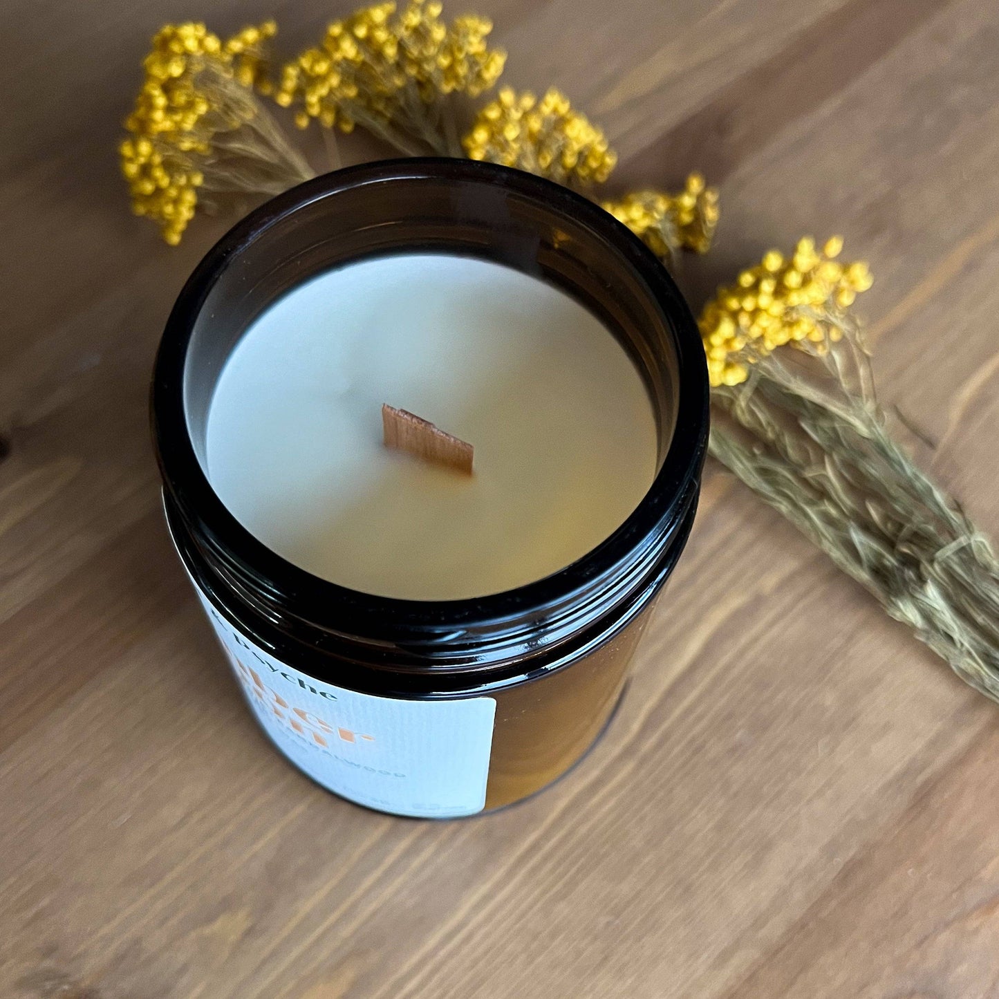 Open Amber Moon Scented Candle in a 7oz amber jar, revealing a wooden wick and coconut soy wax. A warm, inviting home fragrance with amber and sandalwood notes.