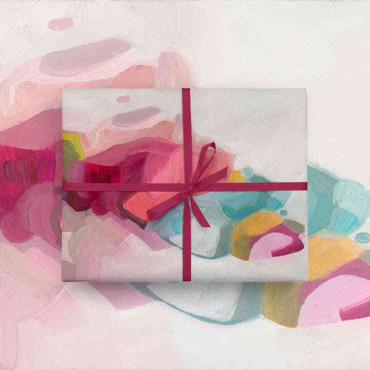 Colourful Gift Wrap featuring abstract pink, red, and teal brushstrokes with a red ribbon, ideal for artistic gift wrapping.