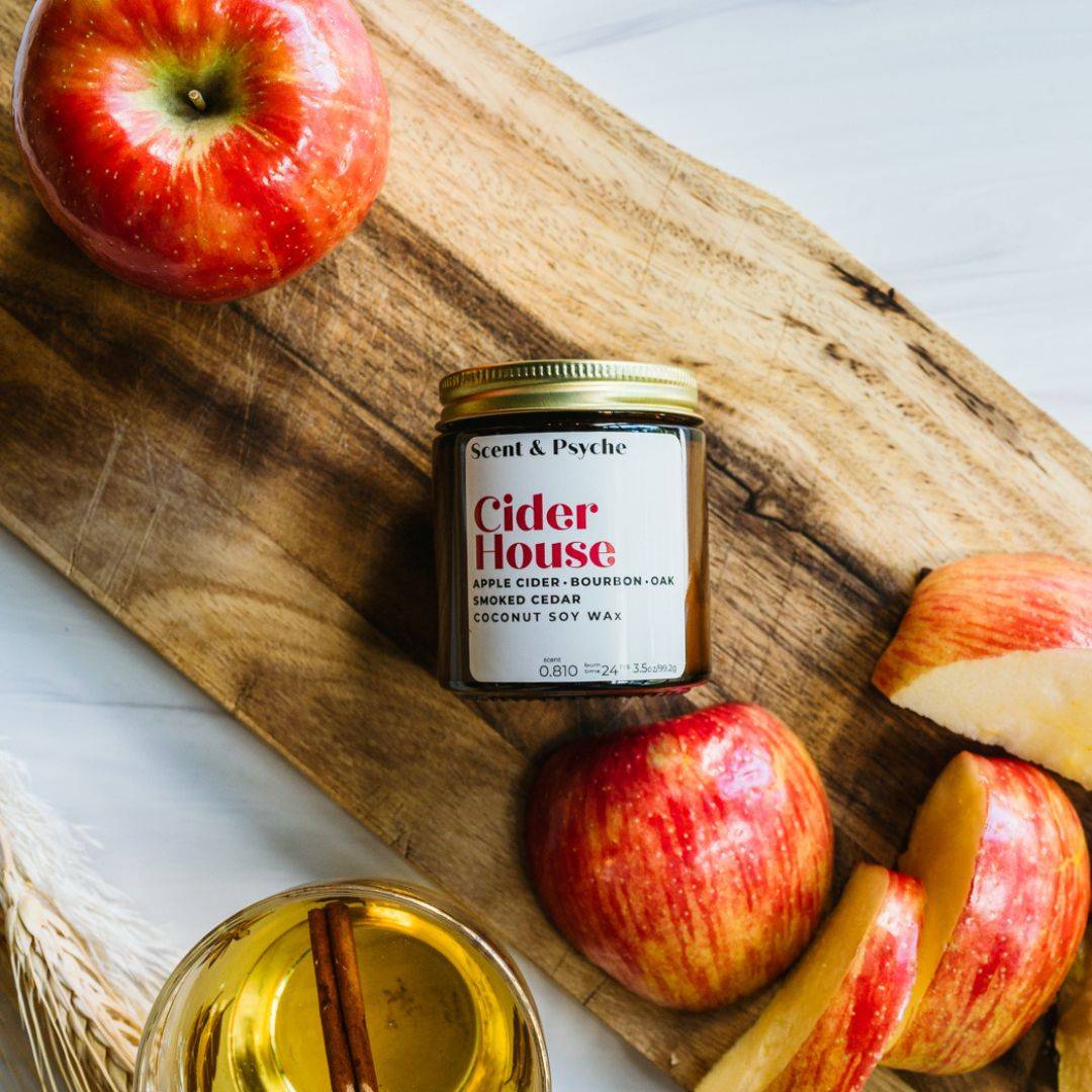 Cider House Scented Candle in a 4oz amber jar with notes of apple cider, bourbon, and smoked cedar. Perfect for fall ambiance and cozy home decor.