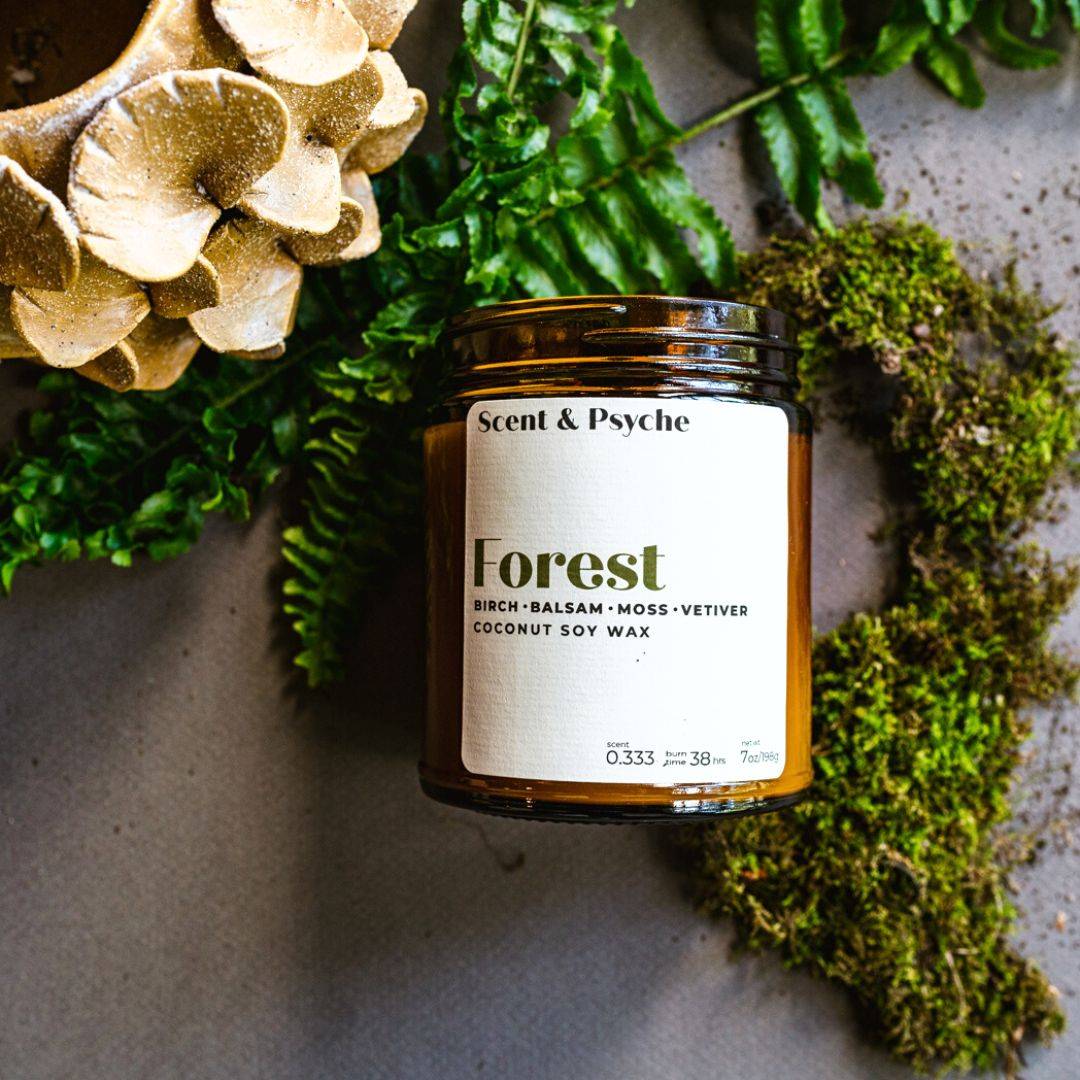 Forest Scented Candle in a 7oz amber jar with birch, balsam, moss, and vetiver fragrance. Perfect for home ambiance and relaxation.