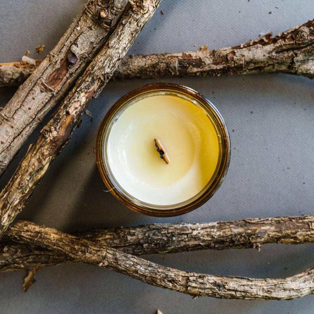 Top view of Embers Scented Candle in a 15oz amber jar, showcasing a smooth coconut soy wax surface with a wooden wick. Ideal for cozy home fragrance.