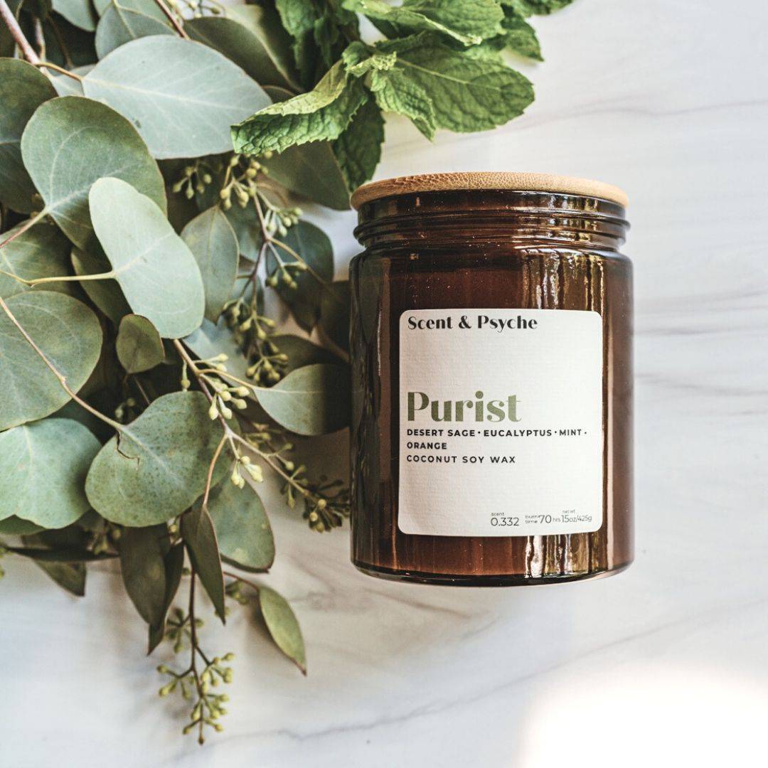 Purist Scented Candle in a 15oz amber jar with a minimalist label, featuring notes of desert sage, eucalyptus, mint, and orange. Made with coconut soy wax for a clean burn.