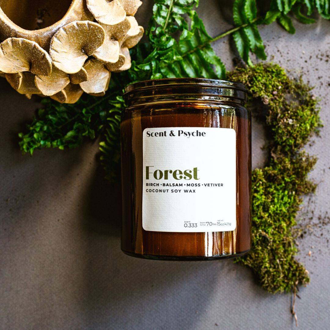 Forest Scented Candle in a 15oz amber jar with a coconut soy wax blend. Features birch, balsam, moss, and vetiver fragrance, perfect for home ambiance.