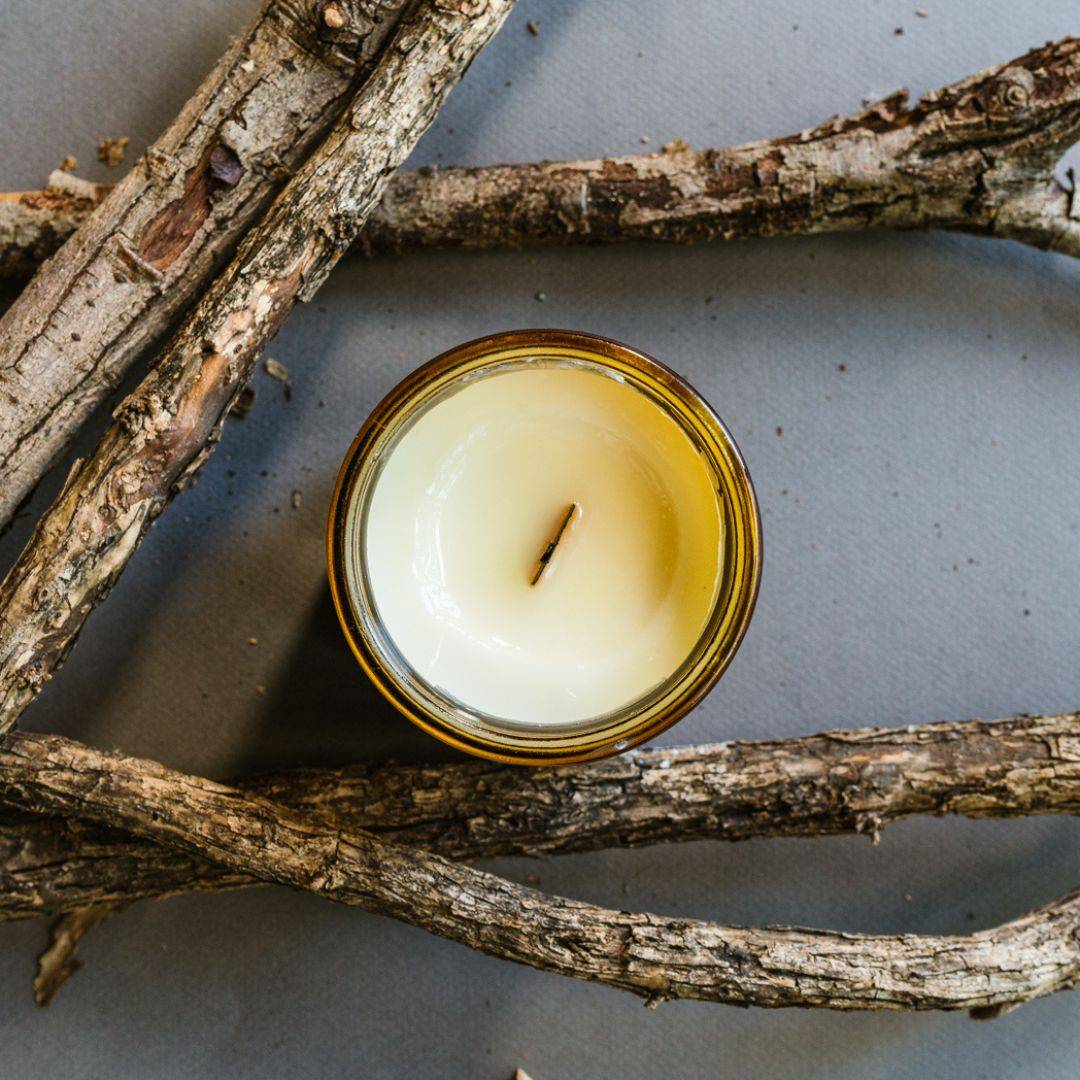 Top view of Embers Scented Candle in a 12oz amber jar, showcasing a smooth coconut soy wax surface with a centered wick. Ideal for home fragrance lovers.