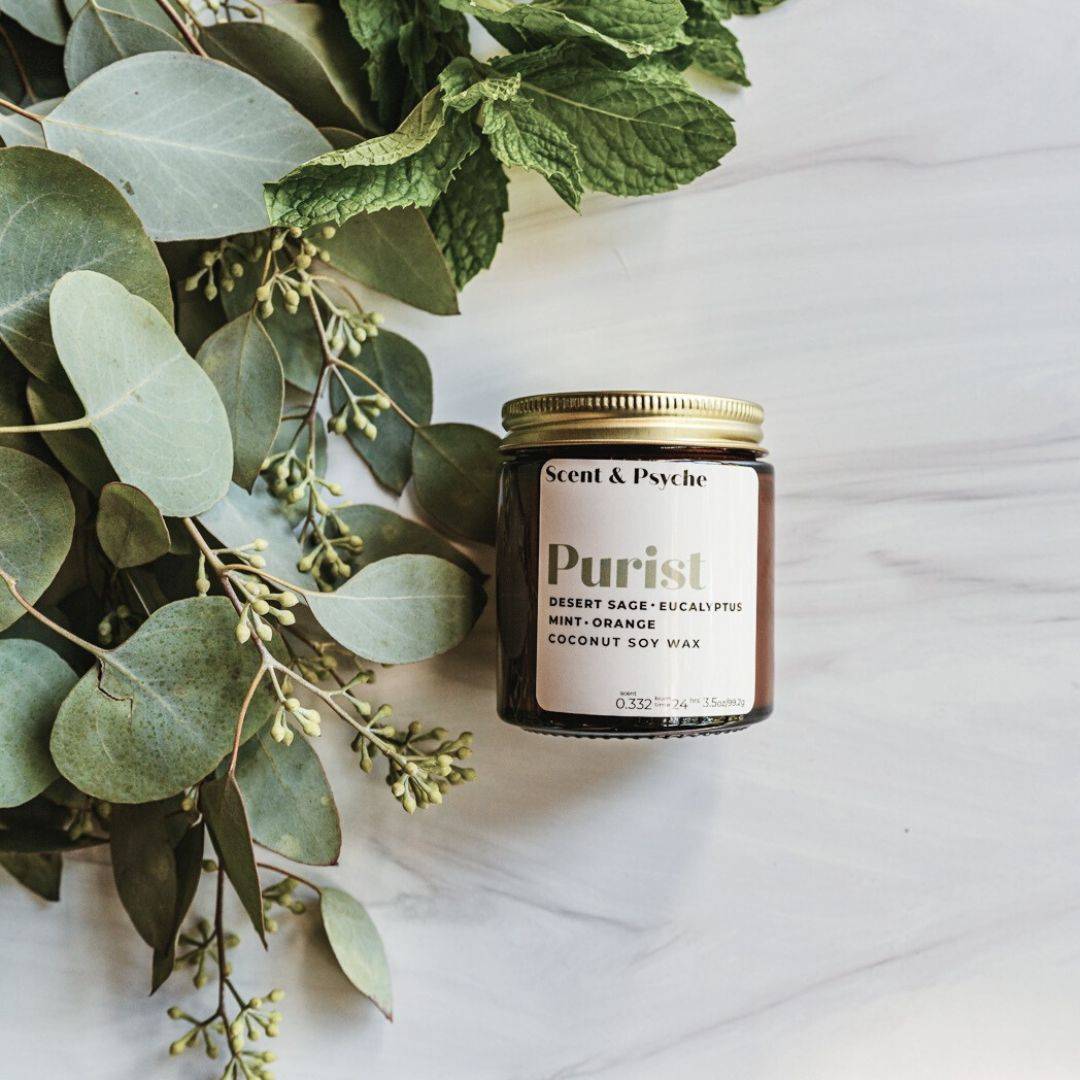 Purist Scented Candle in a 4oz amber jar with a gold lid, featuring a blend of desert sage, eucalyptus, and mint-orange. Perfect for home fragrance.
