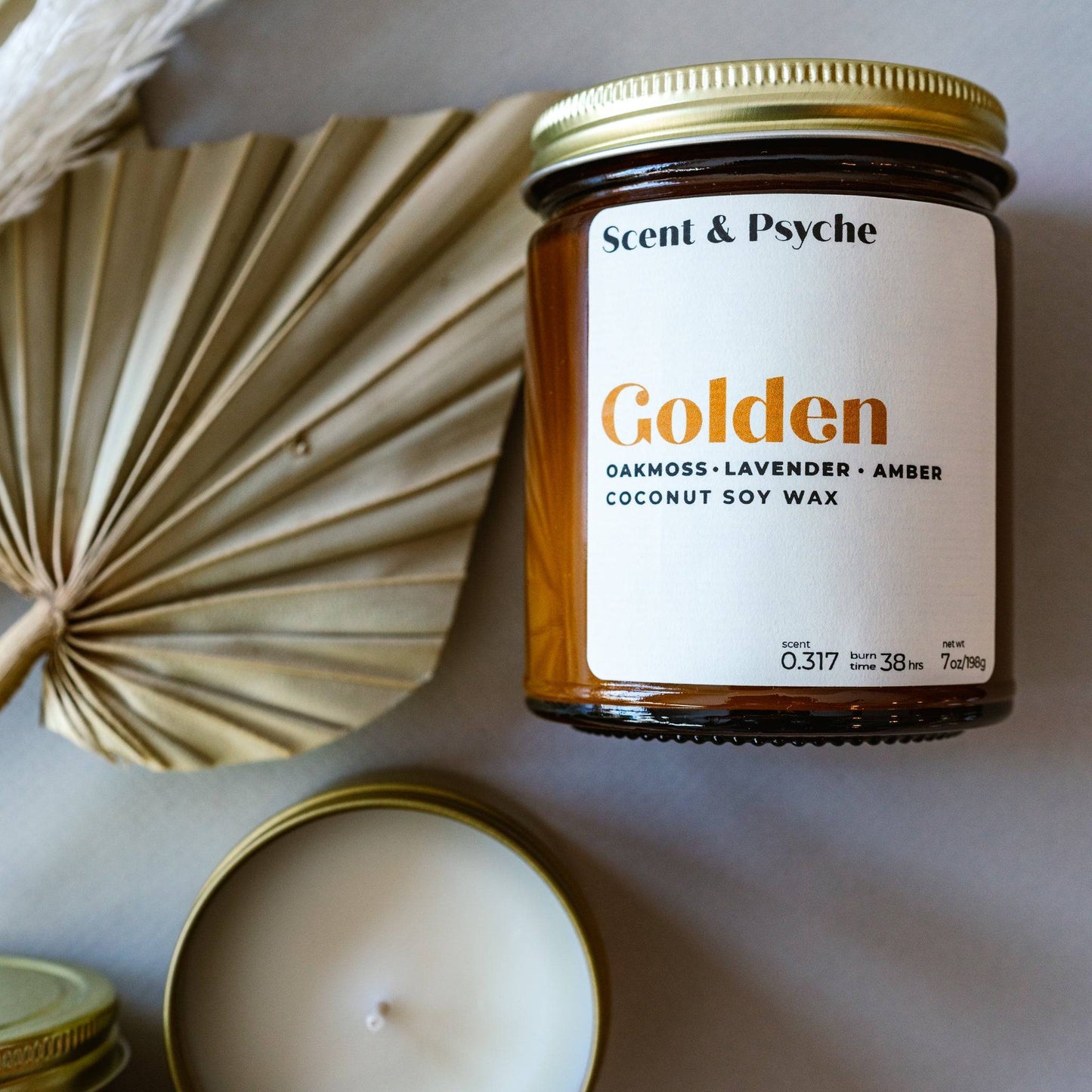 Golden Scented Candle in a 7oz amber jar with a gold lid, featuring oakmoss, lavender, and amber fragrance. Elegant home decor and aromatherapy piece.