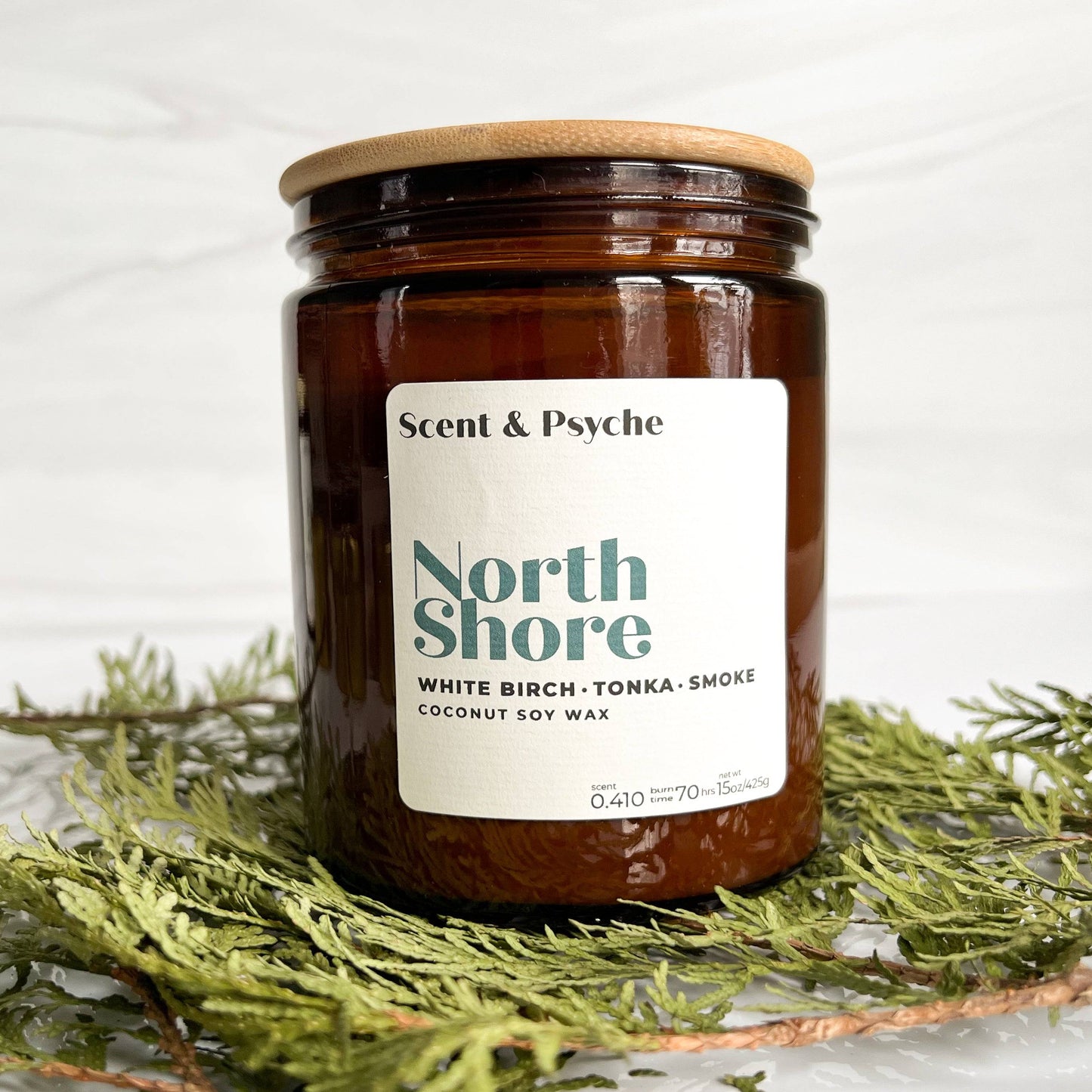 Northshore Scented Candle in a 15oz amber jar with a wooden lid. Features a coconut soy wax blend with white birch, tonka, and smoke fragrance.
