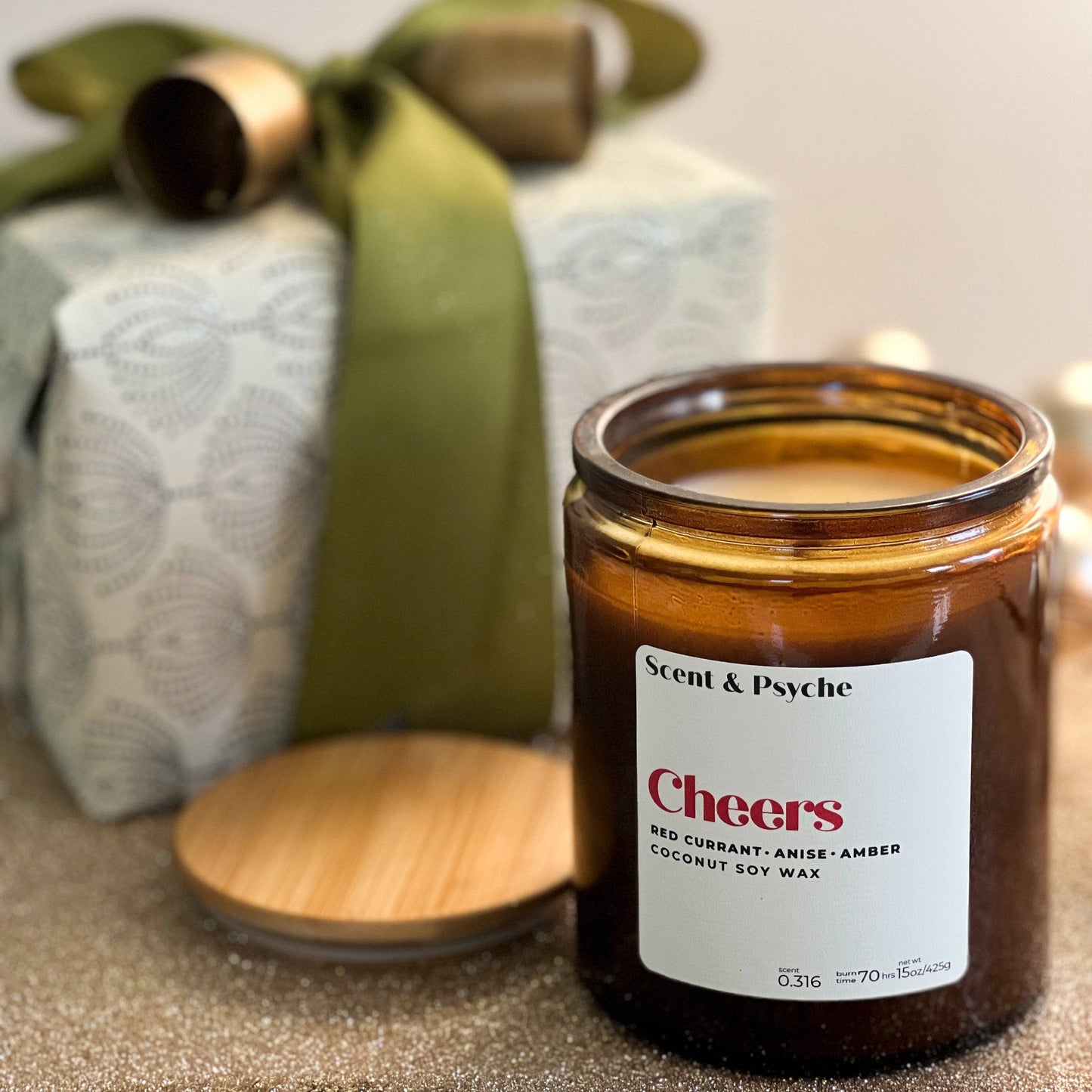 front - Discover the Cheers Scented Candle, a festive holiday candle with black current. anise and amber.  Perfect for holiday celebrations creating a memorable backdrop.