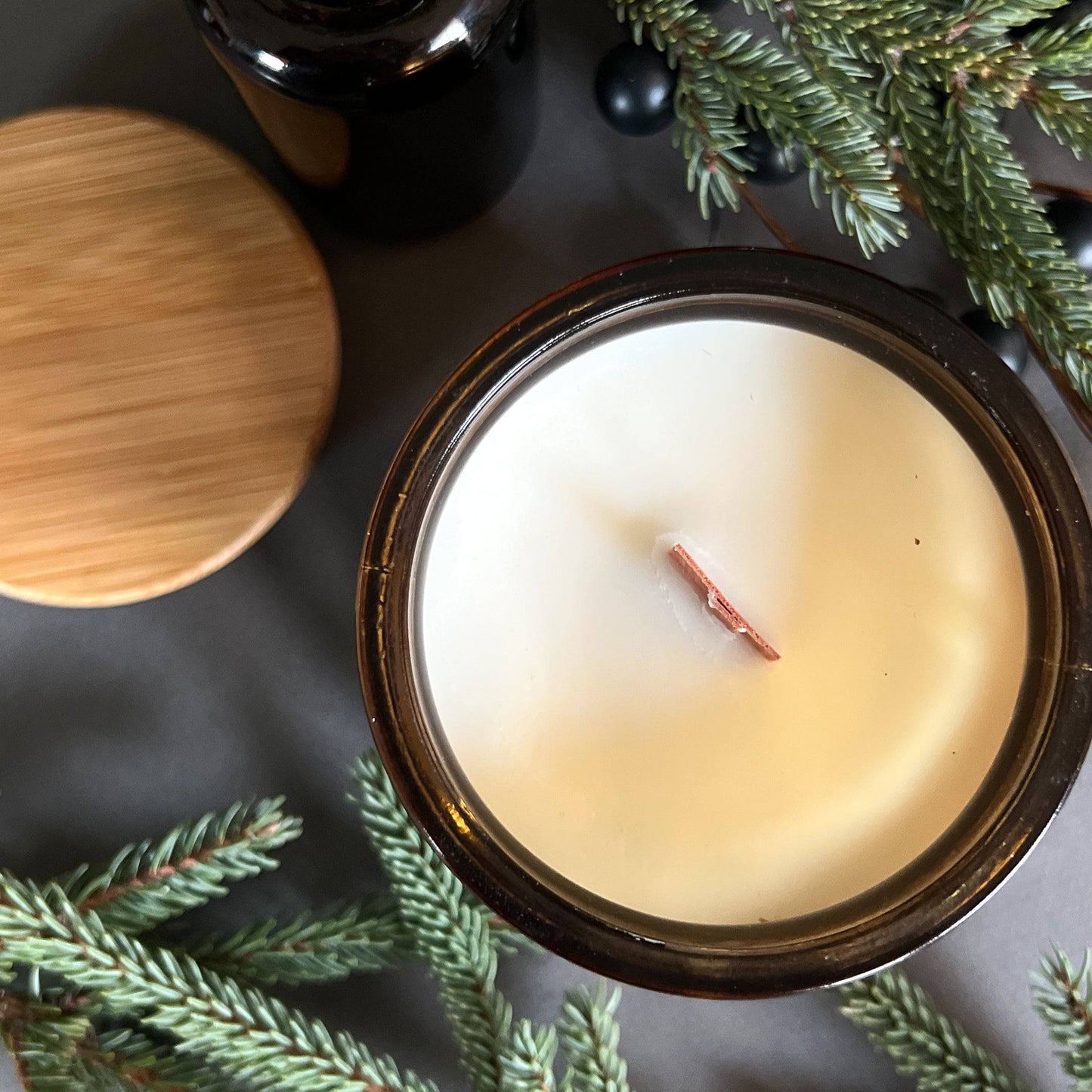 Top view - Frosted Spruce is a holiday scented candle with notes of spruce, moss, and cedar, capturing the fresh scent of a Christmas tree with a rich, woodsy finish.