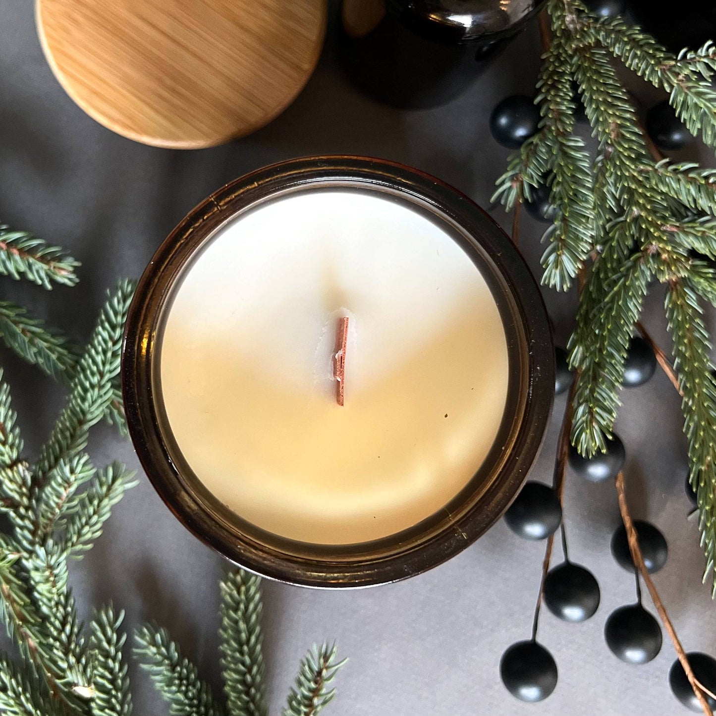 top view Frosted Spruce is a holiday scented candle with notes of spruce, moss, and cedar, capturing the fresh scent of a Christmas tree with a rich, woodsy finish.