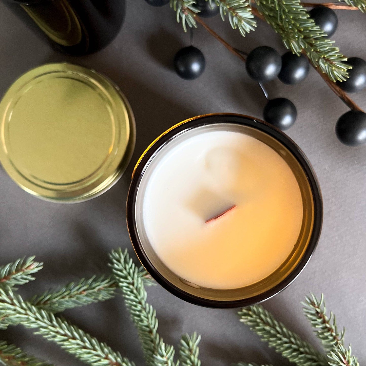 top view Frosted Spruce is a holiday scented candle with notes of spruce, moss, and cedar, capturing the fresh scent of a Christmas tree with a rich, woodsy finish.