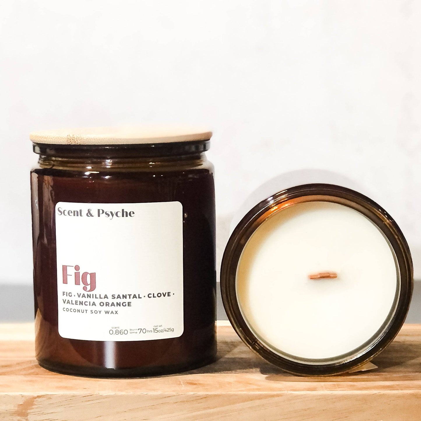 Fig scented candle in a 15oz amber jar with a wooden lid. Features a coconut soy wax blend with notes of fig, vanilla, santal, clove, and Valencia orange.