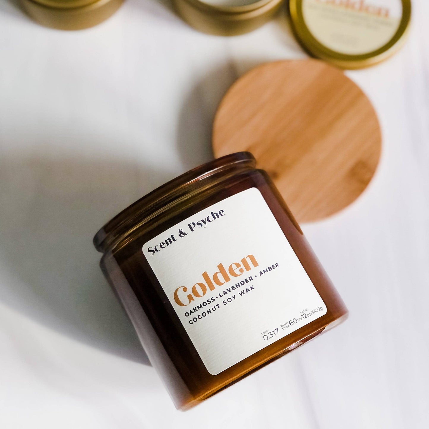 Golden Scented Candle in a 12oz amber jar with a wooden lid, featuring oakmoss, lavender, and amber fragrance. Elegant home decor and aromatherapy piece.