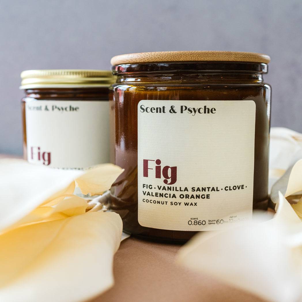 Fig Scented Candle in a 12oz amber jar with a wooden lid, featuring notes of fig, vanilla santal, clove, and Valencia orange. A luxurious home fragrance option.