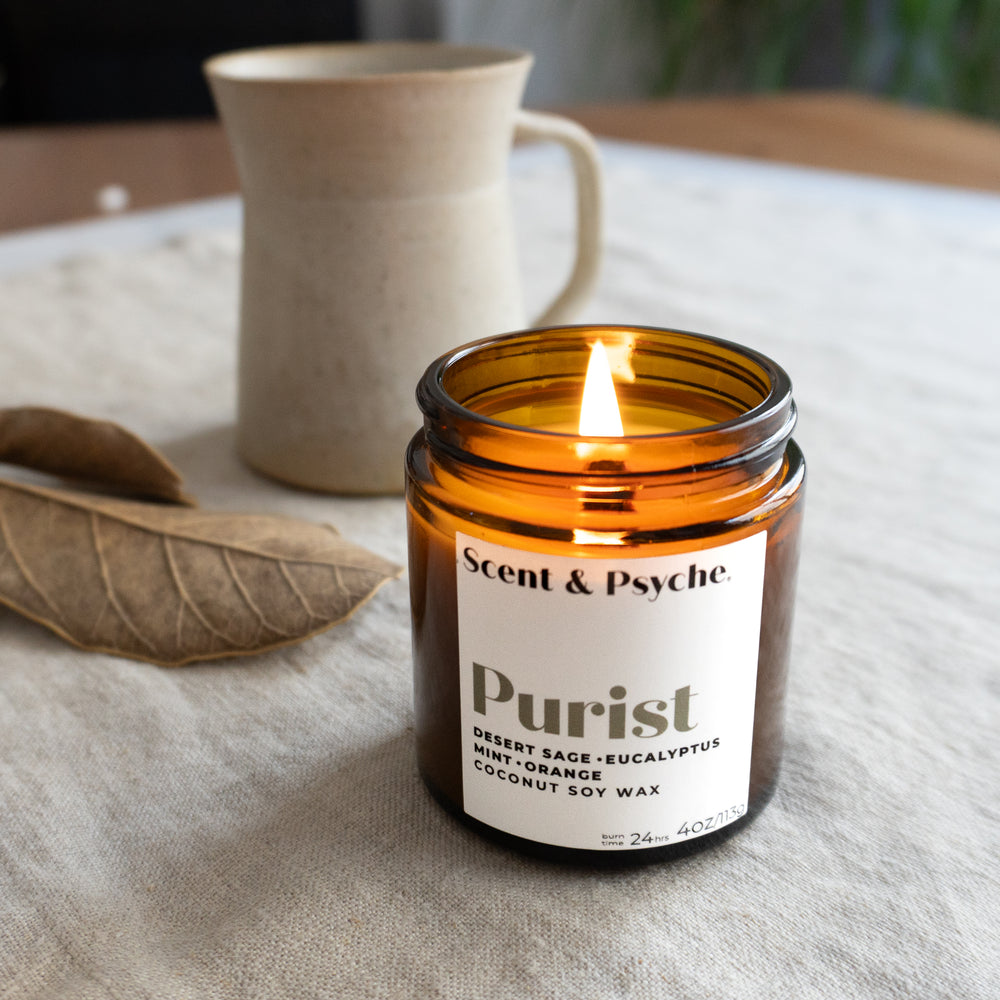 Purist 4oz wood wick scented candle in amber jar with desert sage, eucalyptus, and mint notes, ideal for home fragrance and calming ambiance.