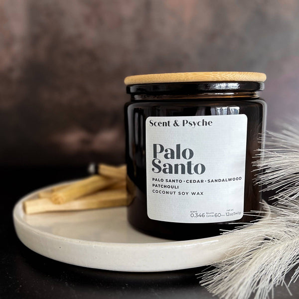 Palo Santo Scented Candle in a 12oz amber jar with a wooden lid, featuring notes of cedar, sandalwood, and patchouli. Aesthetic home fragrance decor.